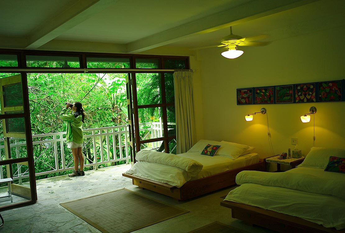 Canopy Lodge accommodations, woman on balcony