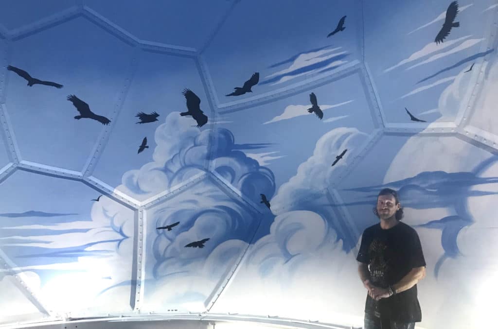 Joe with mural inside dome