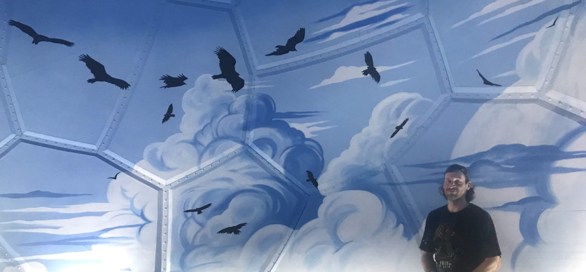 Joe with mural inside dome